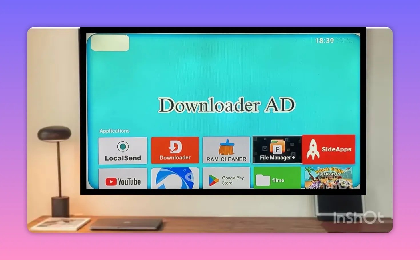 TV screen displaying Downloader AD icons including LocalSend, Downloader, RAM Cleaner, File Manager+, and SideApps